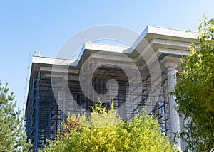 Reconstruction of the building. Scaffolding stands near the building. Town-planning. Subcontractor. photo