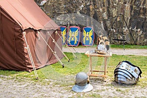 Reconstruction of a military camp with tents and armor from the Middle Ages