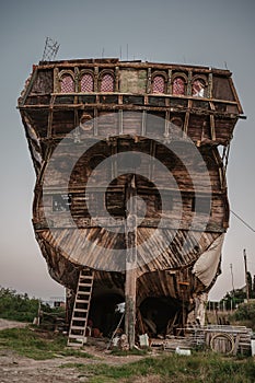 Reconstruction. The stern of an old sailboat with windows on board. Rear view on board a sailing boat.