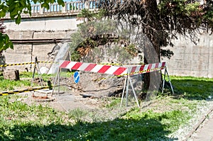 Reconstruction of underground heating pipeline system in the city, underground pipe work with safety barrier