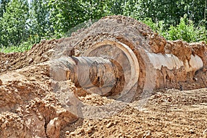 Reconstruction of the water supply network. An old water pipe in a reinforced concrete sleeve was dug out