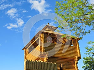 Reconstruction of a wooden fortification on the background blue sky