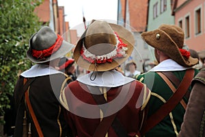 Reconstructors in musketeers clothes on a city holiday