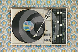 Record player on top of flower wallpaper