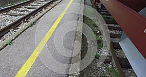 Recorded video close up of parked freight wagons on the blue sky platform in the background.