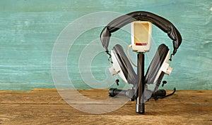 Recording podcast or audiobook concept,with headphones and vintage microphone, copy space