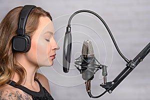 Recording a speech on a radio station, announcer, or singer, blogger works in the studio with a studio microphone. Concept of