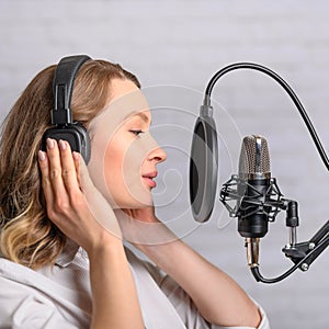 Recording speech on radio stations, the announcer works in the studio with a studio microphone. Square photo for instagram