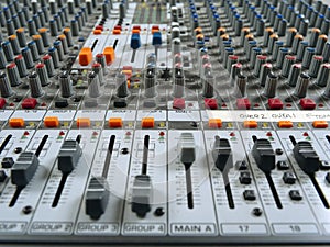Recording studio mixing board showing faders