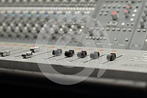 Recording Studio Mixing Desk at an angle with focus on faders