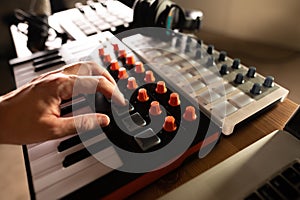Recording studio, music studio. Musician`s hand on the keys of a midi keyboard. Professional musical equipment. Sound work,