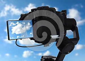 Recording view of sky with clouds on professional video camera