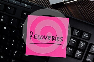 Recoveries write on sticky notes isolated on office desk