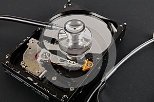 RECOVERY AND REPAIR TECHNOLOGY CONCEPT: Hard Disk Drive HDD with stethoscope isolated on a black background.