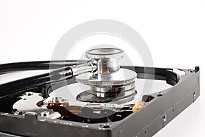 RECOVERY AND REPAIR TECHNOLOGY CONCEPT: Hard Disk Drive HDD with stethoscope isolated on white.