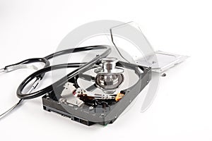 RECOVERY AND REPAIR TECHNOLOGY CONCEPT: Hard Disk Drive HDD with stethoscope isolated on white.