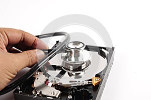 RECOVERY AND REPAIR TECHNOLOGY CONCEPT: Hard Disk Drive HDD with stethoscope isolated on white.