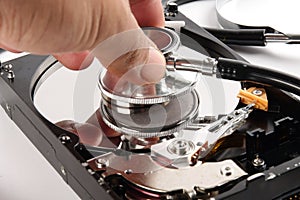 RECOVERY AND REPAIR TECHNOLOGY CONCEPT: Hard Disk Drive HDD with stethoscope isolated on white.