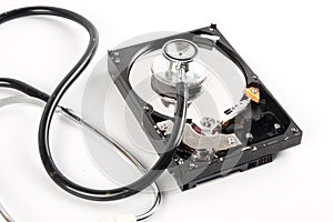 RECOVERY AND REPAIR TECHNOLOGY CONCEPT: Hard Disk Drive HDD with stethoscope isolated on white.