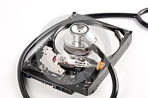 RECOVERY AND REPAIR TECHNOLOGY CONCEPT: Hard Disk Drive HDD with stethoscope isolated on white.