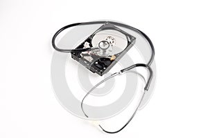 RECOVERY AND REPAIR TECHNOLOGY CONCEPT: Hard Disk Drive HDD with stethoscope isolated on white.