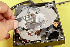 RECOVERY AND REPAIR TECHNOLOGY CONCEPT: Hard Disk Drive HDD with stethoscope isolated on a yellow background