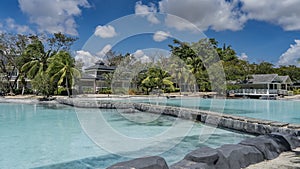 A recreation area in the tropics. A large swimming pool with turquoise water