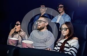 Recreation and leisure. Emotional friends watching 3D film in cinema