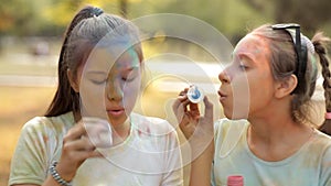 In the recreation park, children blow bubbles. Children`s entertainment in the recreation park. Holiday holi