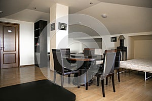 a recreation room with black furniture in the attic