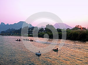 Recreation.Tourist kakaking and tubing along the river photo