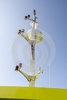Recreational boat mast with signal lights, radar and a string of garlic to ward