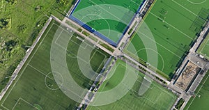 Recreational green grass active sports hockey and football fields overhead top down view. Competition court active