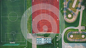 Recreational green grass active sports hockey and football fields overhead top down view. Competition court active outdoor people