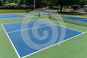 Recreational sport of pickleball court in Michigan, USA looking at an empty blue and green new court at a outdoor park