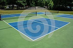 Recreational sport of pickleball court in Michigan, USA looking at an empty blue and green new court at a outdoor park