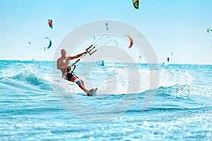 Recreational Sports. Man Kiteboarding In Sea Water. Extreme Sport Action