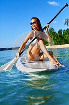 Recreational Sports. Woman Stand Up Paddle Boarding ( Surfing ).
