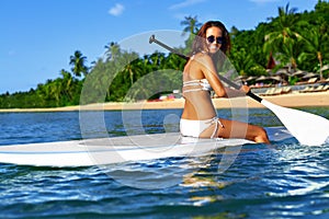 Recreational Sports. Woman Stand Up Paddle Boarding ( Surfing ). photo