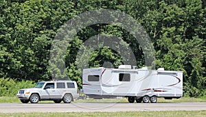 Recreational vehicle being towed along a U.S. interstate highway.