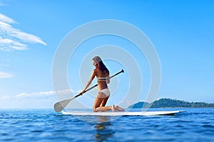 Recreational Water Sports. Woman Paddling On Surf Board. Summer