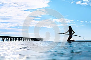 Recreational Water Sports. Woman Silhouette On Surfboard In Ocean. Wellness