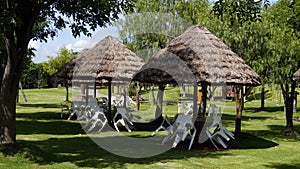 Recreative park benches and palm leaves tents photo