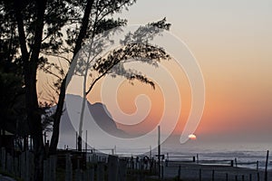 Recreio dos Bandeirantes beach at sunrise with the Pedra da Gavea mountain