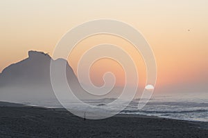 Recreio dos Bandeirantes beach at sunrise with the Pedra da Gavea mountain