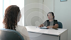 Recruiter or job interviewer conducting an interview with a job seeker in an office room.