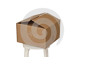 Rectangle cardboard box on beige stool for creative arts and toy storage