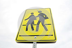 rectangle pedestrian school zone crossing sign, black print on yellow background