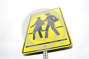 rectangle pedestrian school zone crossing sign, black print on yellow background