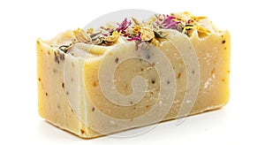 A rectangular bar of artisanal soap with a creamy beige color, speckled with small